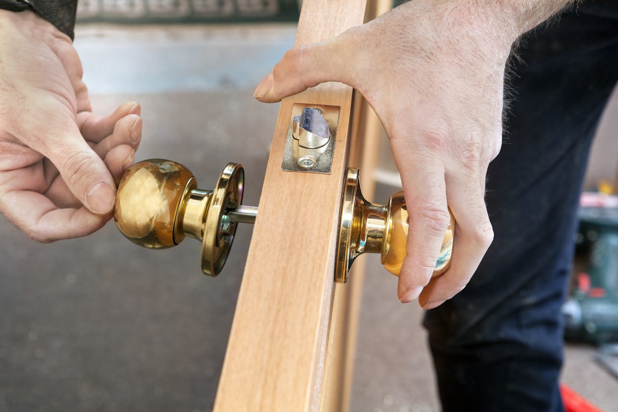 A door being repaired, including the mechanism and door knob